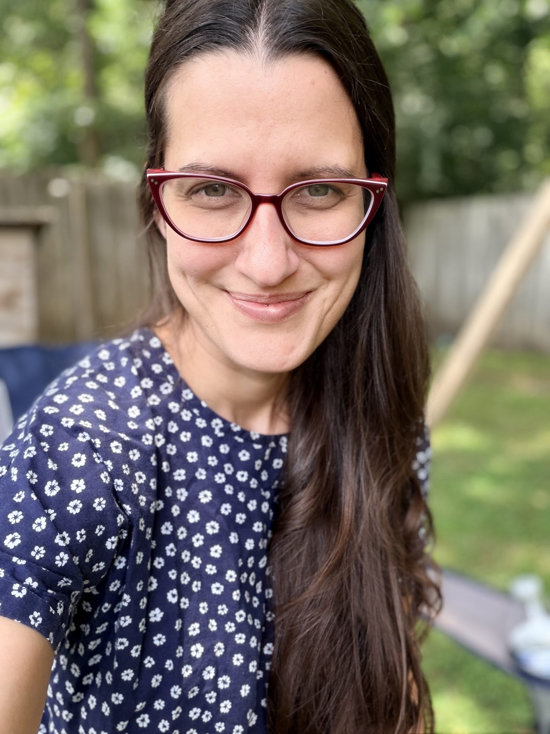 Sarah, founder of The Steadfast Table, smiling outdoors